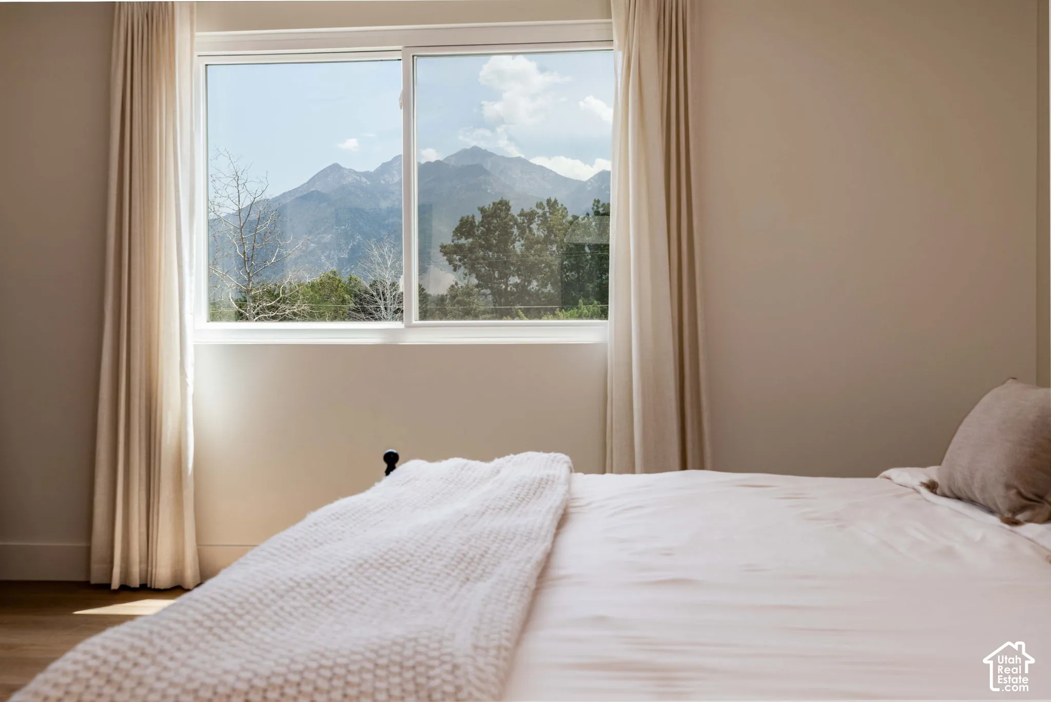 Bedroom featuring a large window with a mountain backdrop