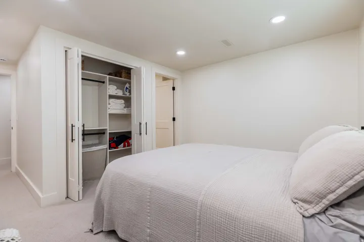 Bedroom featuring recessed lighting, a built-in closet with bifold doors, integrated shelving, and hanging rods
