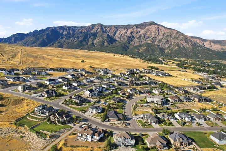 Expansive residential area featuring a diverse collection of single-family homes with varied architectural styles, paved roadways, and landscaped properties