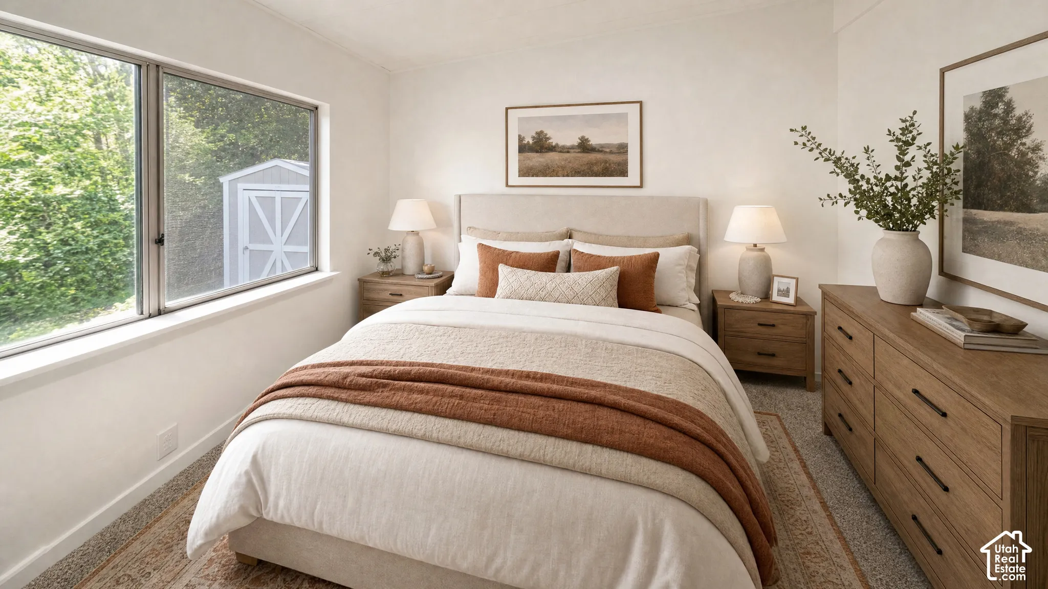 Bedroom featuring a large window, light-colored walls, and carpeting