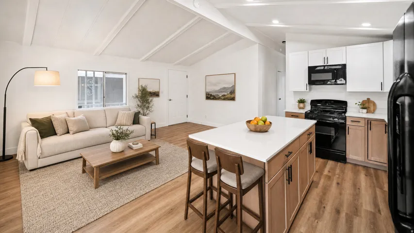 Open-concept living area and kitchen featuring vaulted ceilings, wood-finish flooring, a kitchen island with seating, a white subway tile backsplash, and dark appliances