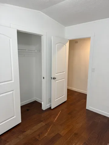 Rich wood-finish flooring complements crisp white walls and trim