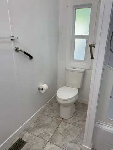 White commode with a privacy window