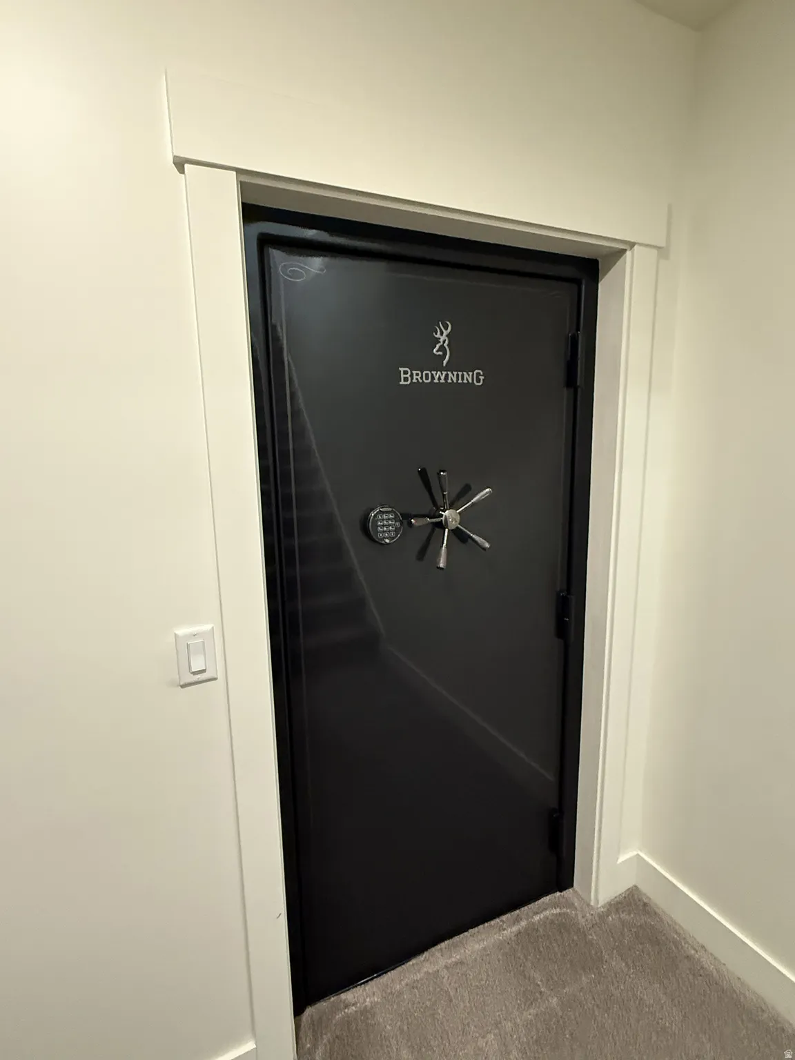 Built-in black safe with a combination lock and multi-spoke handle