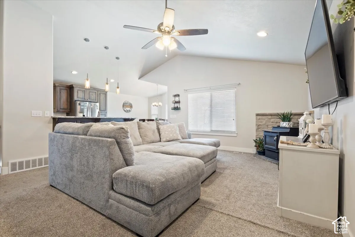 Living area with vaulted ceiling and recessed lighting