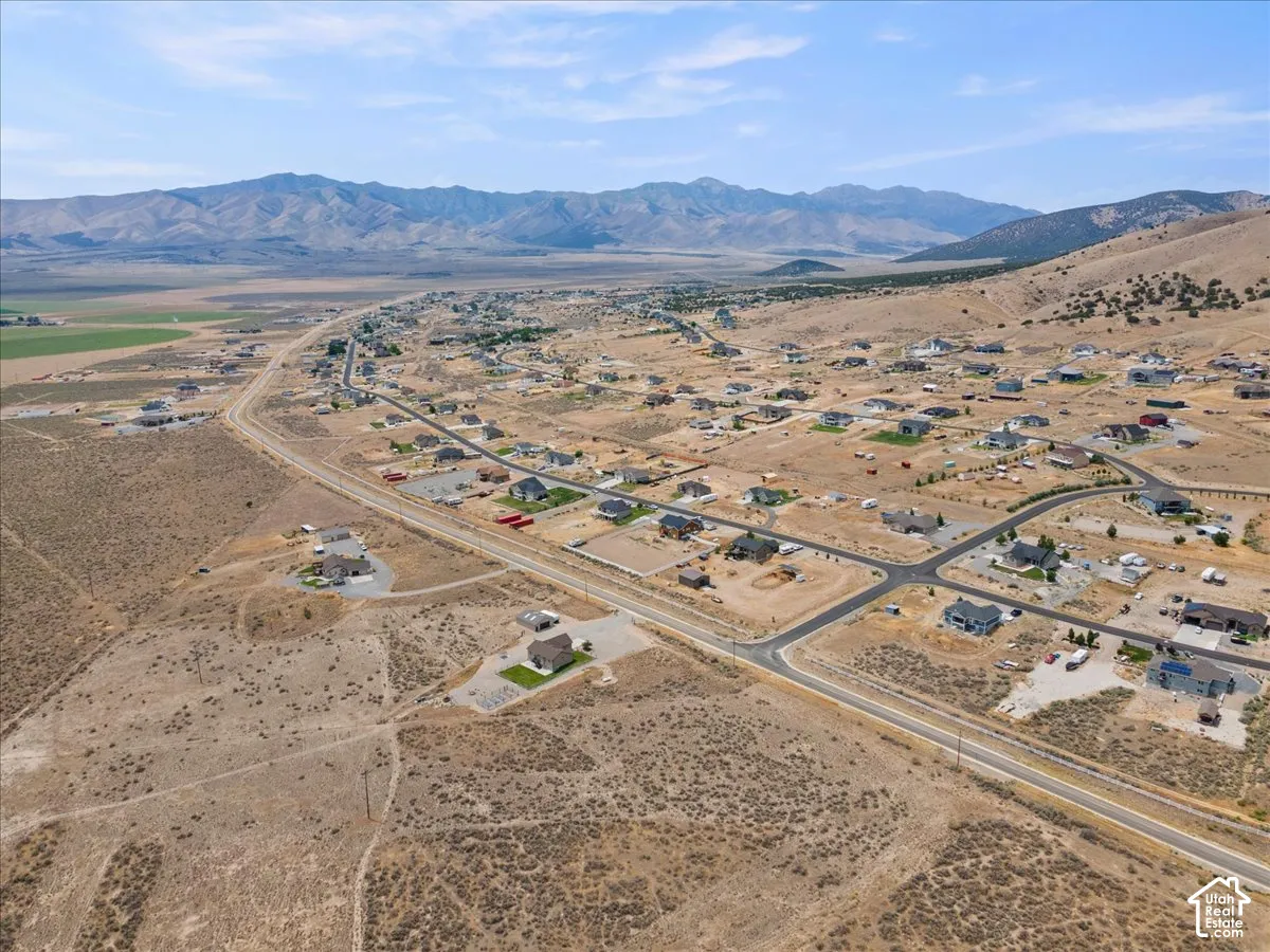 Aerial perspective showcasing a residential development with mountain backdrops