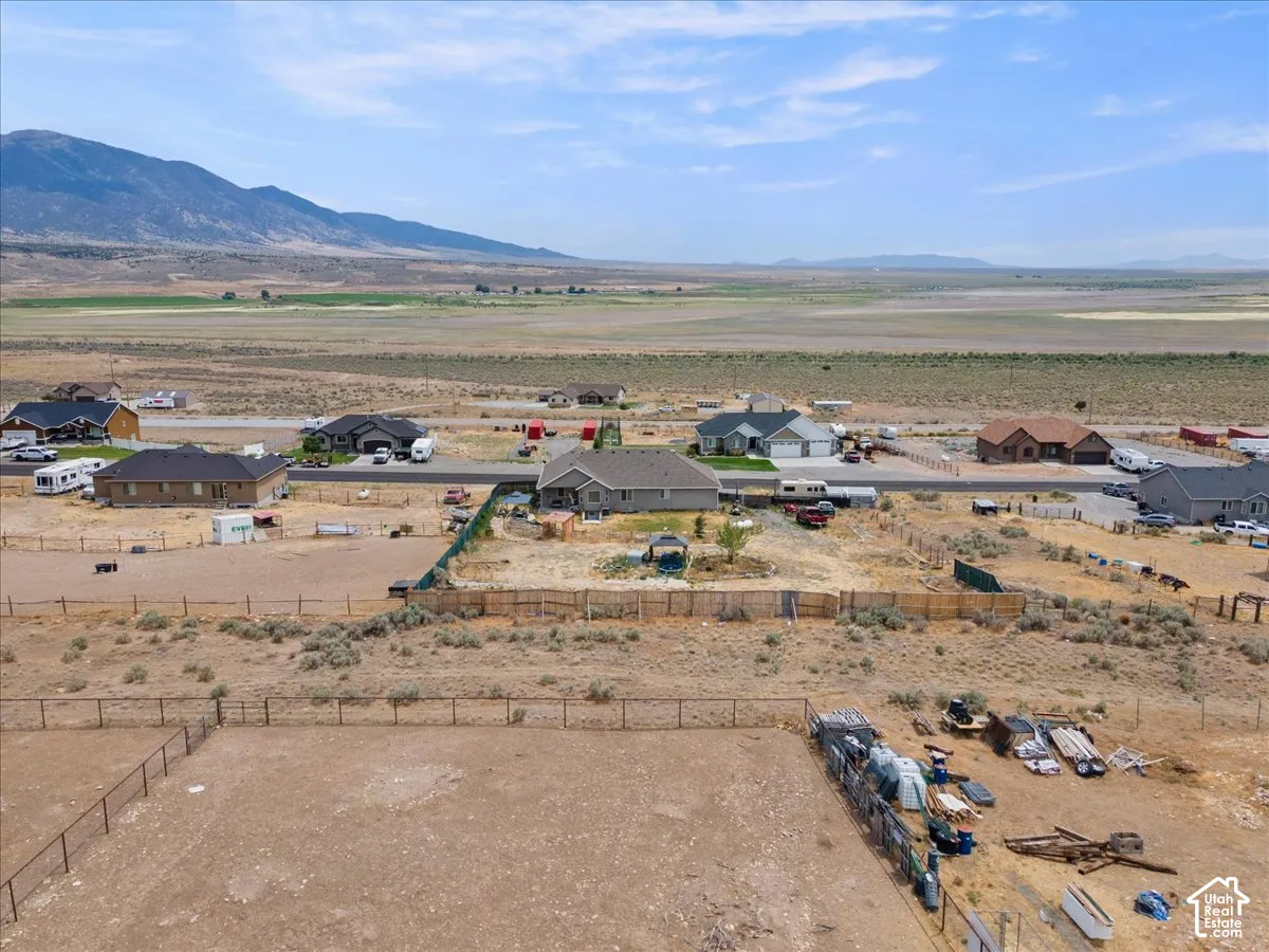 Expansive property with a fenced perimeter and surrounding desert landscape