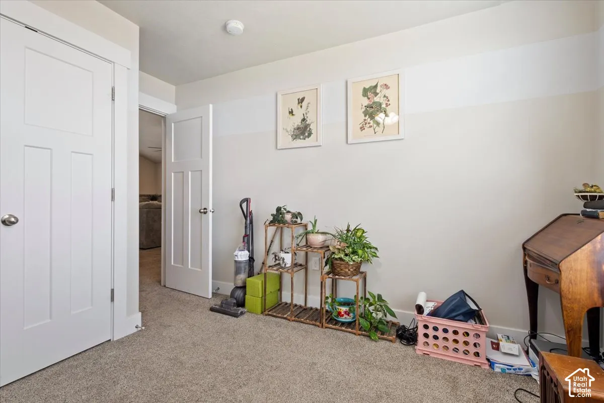 Carpeted room featuring white panel doors with brushed nickel hardware and a neutral wall color palette