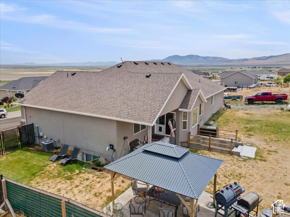 Exterior stucco siding and shingle roofline