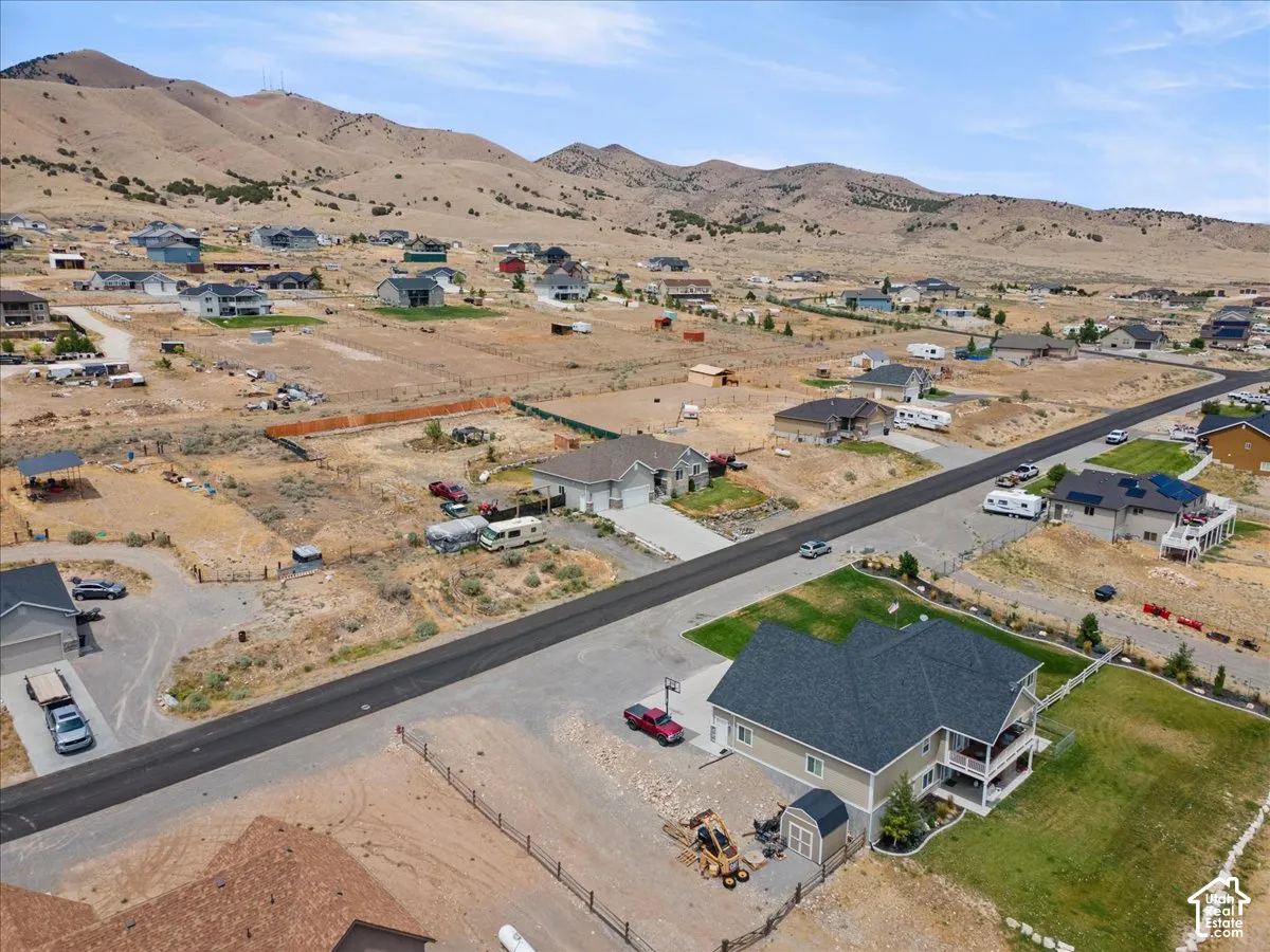 Aerial perspective showcasing residential properties with a mountainous backdrop