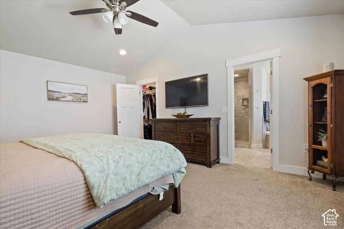 Vaulted ceiling with recessed lighting and ceiling fan