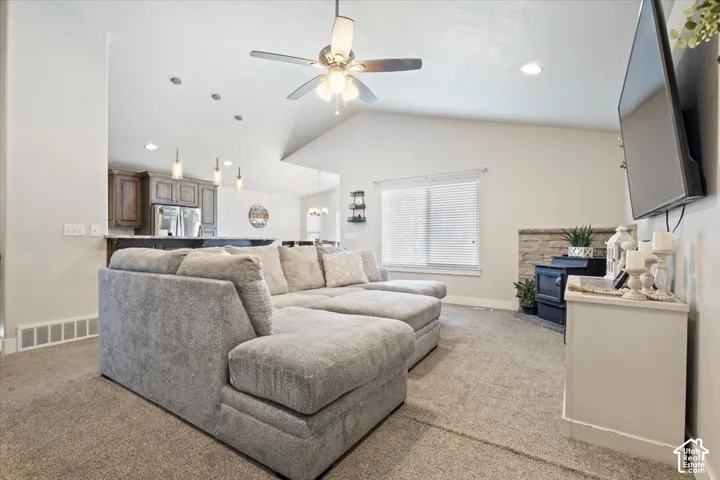 Living area with vaulted ceiling and recessed lighting