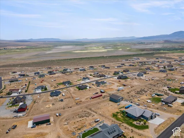 Aerial perspective showcasing a residential development with scattered homes and expansive undeveloped land