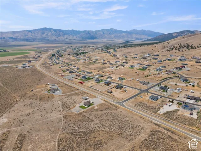 Aerial perspective showcasing a residential development with mountain backdrops