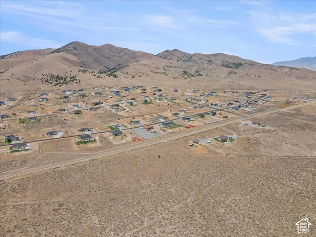 Expansive landscape featuring distant mountains framing a residential development