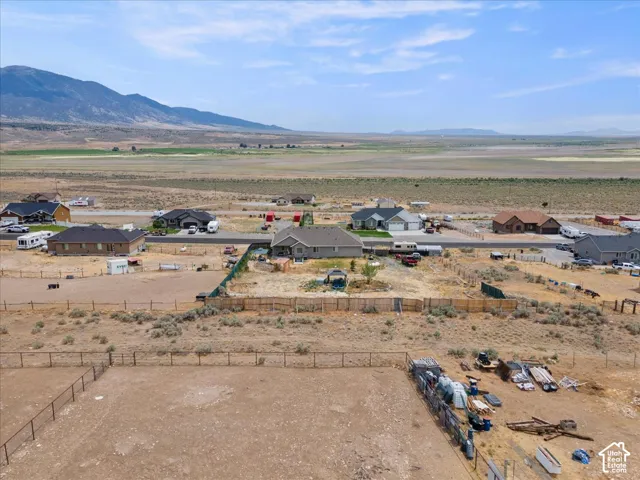 Expansive property with a fenced perimeter and surrounding desert landscape