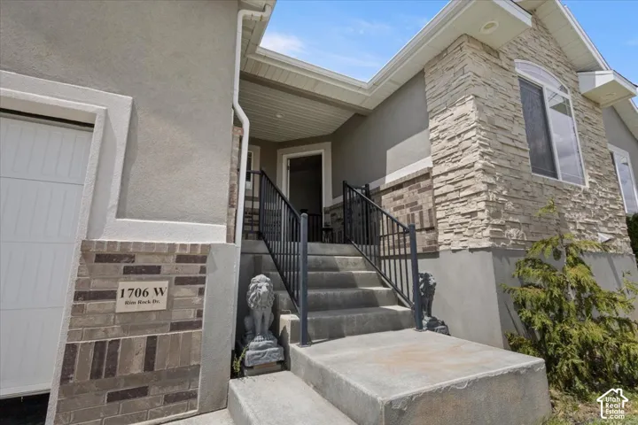 Multi-textured exterior featuring stucco, stone veneer, and brick accents