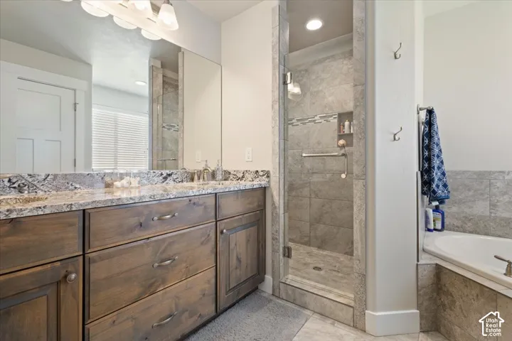 Double vanity with a speckled granite countertop and under-mount sinks