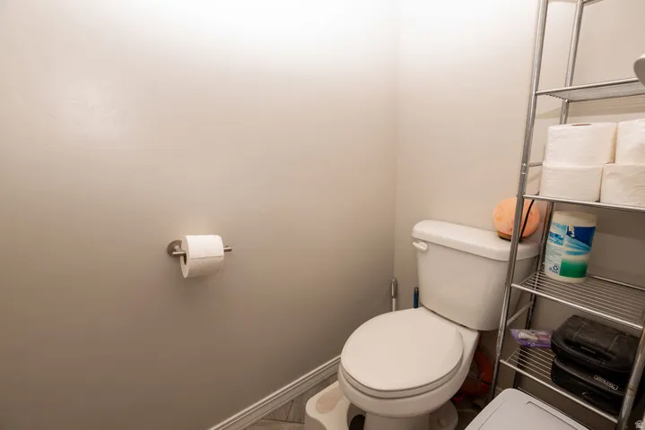 White toilet fixture with a chrome toilet paper holder