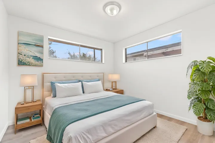 Bedroom featuring light wood-finish flooring and white walls w/ virtual staging