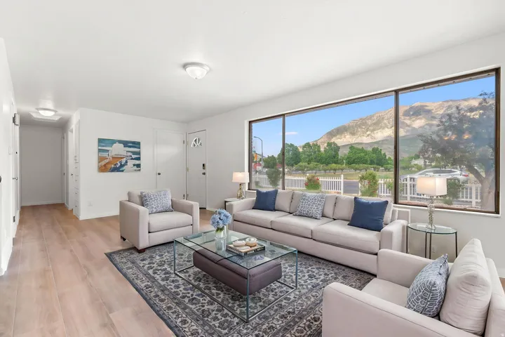 Expansive picture windows showcasing mountain scenery and streetscape w/ virtual staging