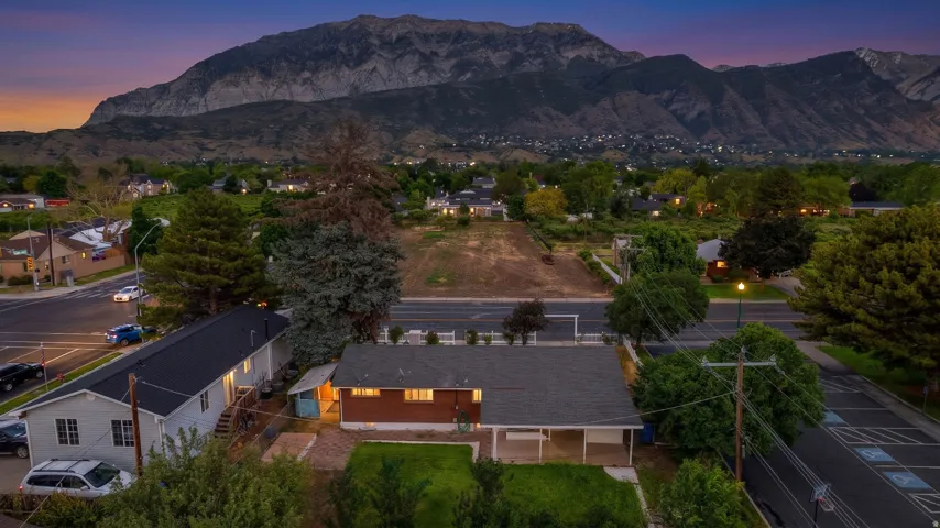 Mountain backdrop with residential properties and developed roads