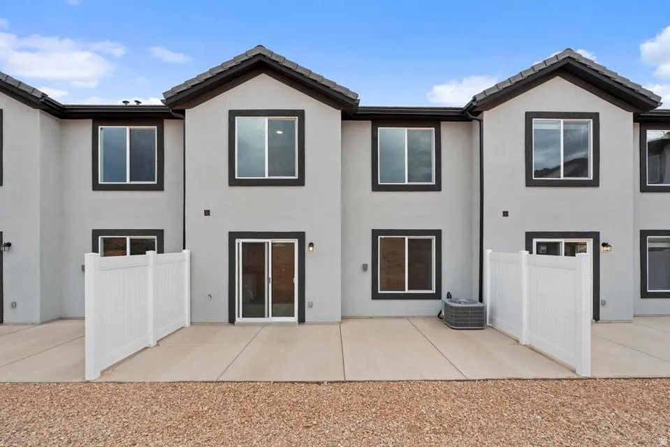 Contemporary multi-level exterior with a light stucco finish and dark trim