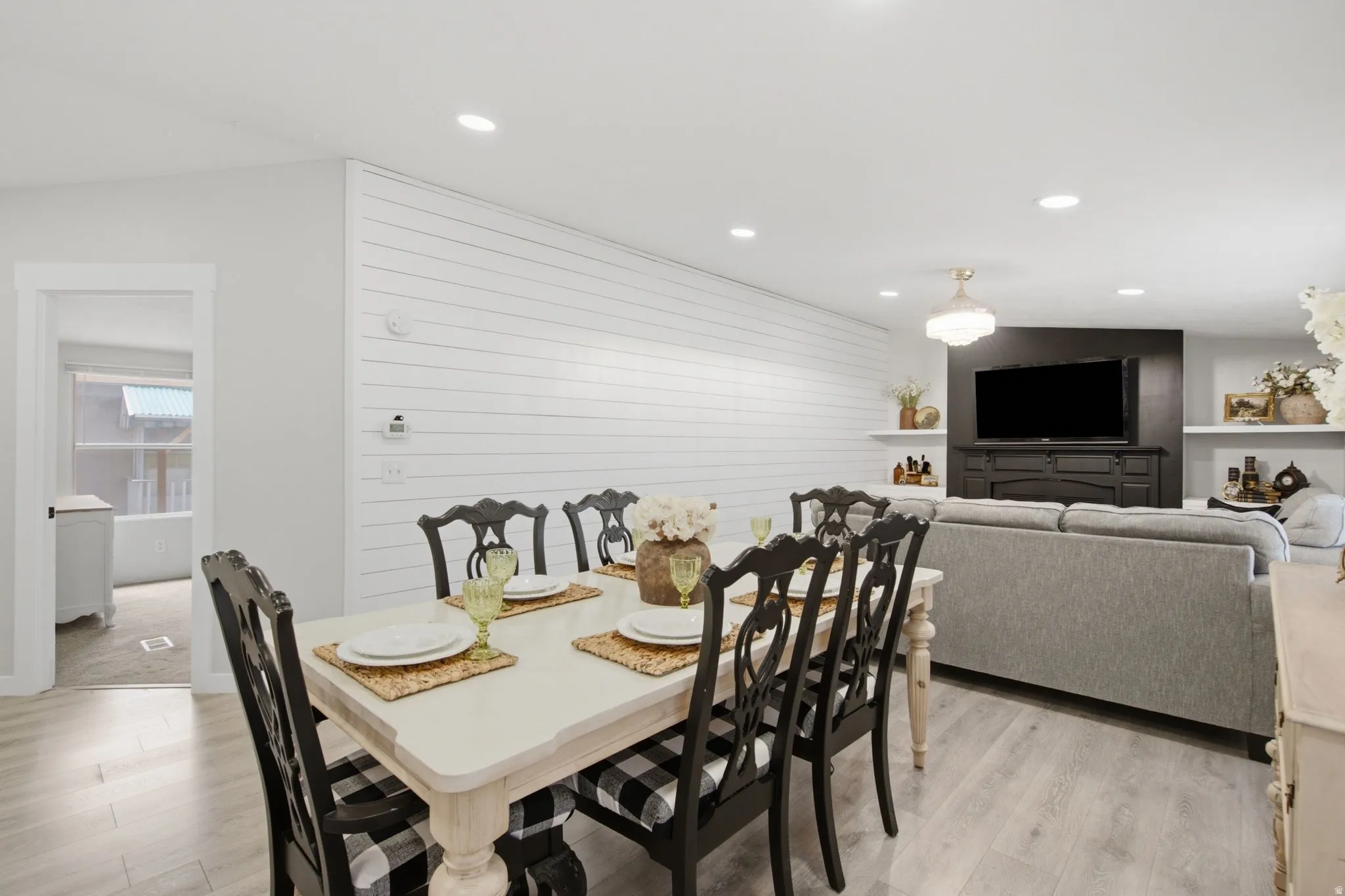 Open-concept living area with light wood-finish flooring