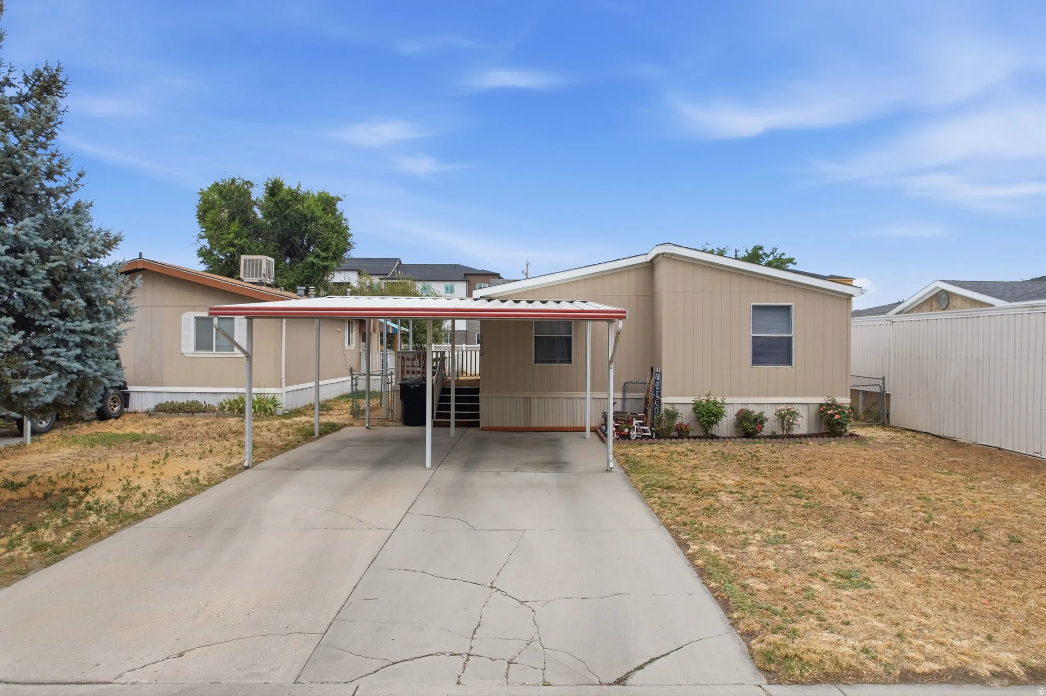 Carport with a concrete driveway and side entry
