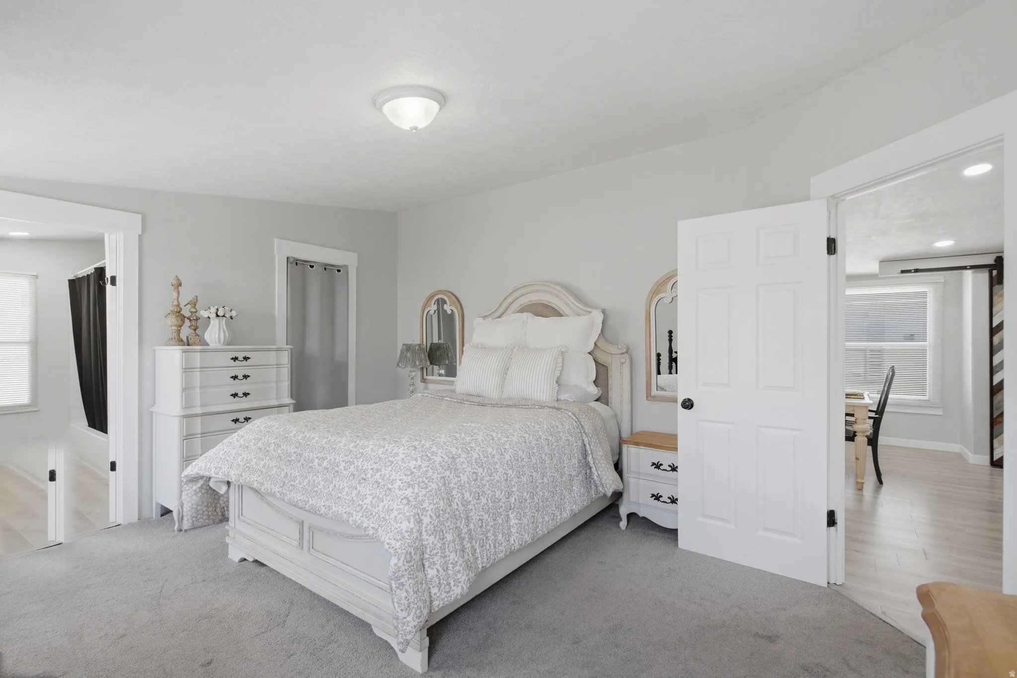 Carpeted room with light gray walls, a flush-mount ceiling light, white trim, and white paneled doors