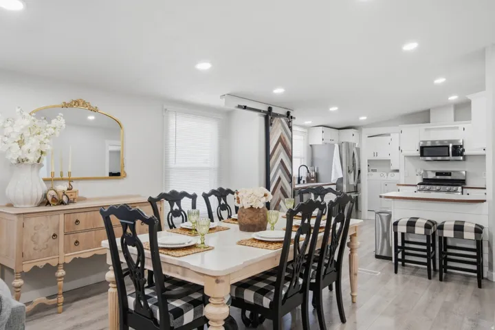 Dining area with wood-finish flooring and recessed lighting