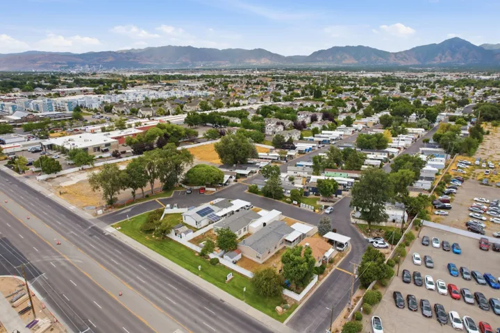 Expansive aerial perspective showcasing a neighborhood setting with mountain backdrops
