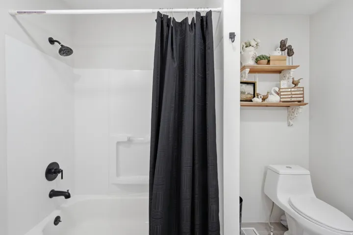 White tub/shower combination with matte black fixtures