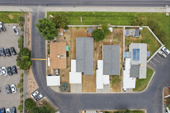Aerial property overview showcasing multiple residential structures with varied roofing materials