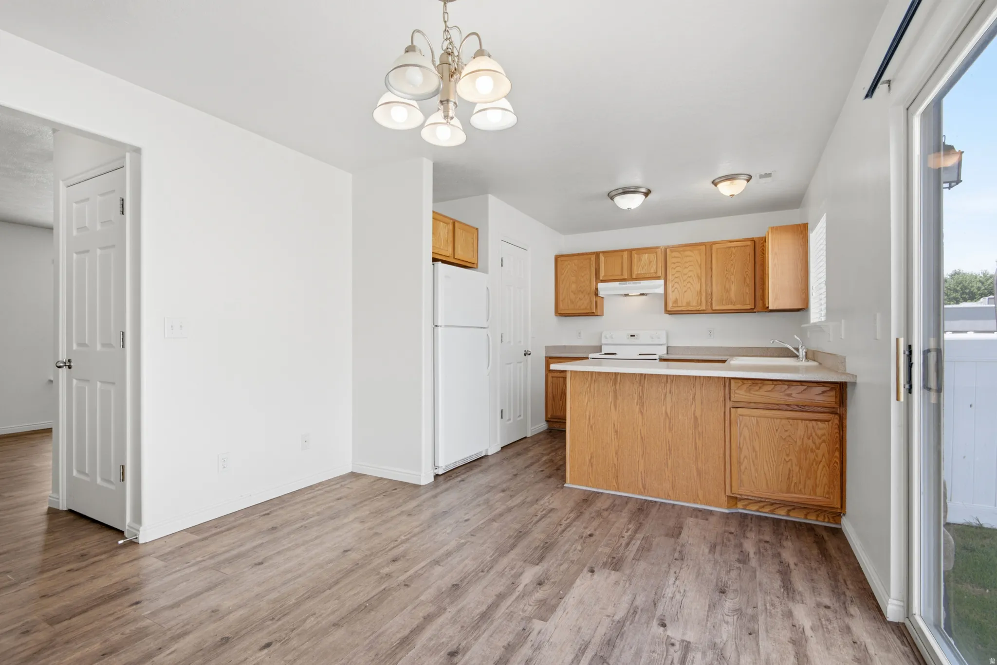 Kitchen and dining area featuring wood-finish flooring