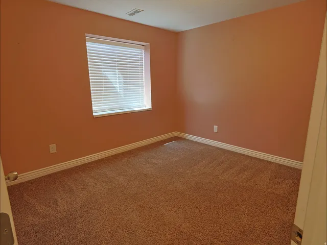 Warm-toned walls complement plush carpeting