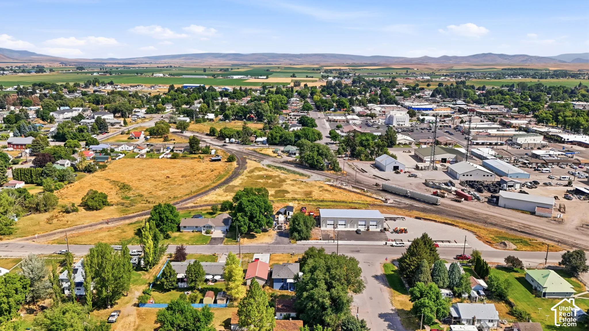 Aerial perspective showcasing the community, surrounded by agricultural fields and distant hills