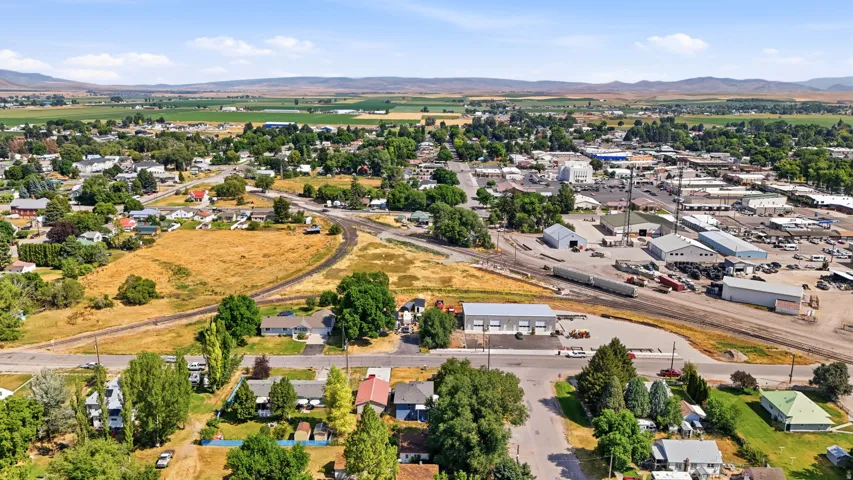 Aerial perspective showcasing the community, surrounded by agricultural fields and distant hills