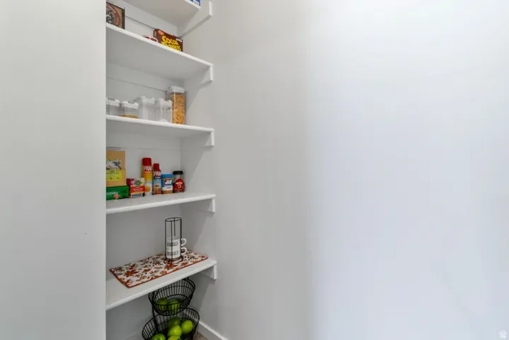 Built-in pantry shelving featuring white painted wood construction