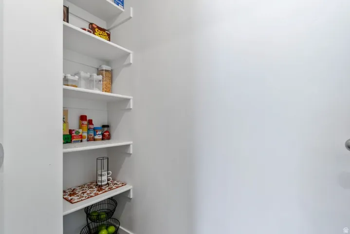 Built-in pantry shelving featuring multiple tiers and a white finish