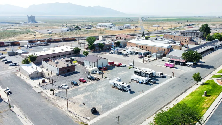 Aerial overview of a commercial district featuring multiple buildings and extensive paved parking areas