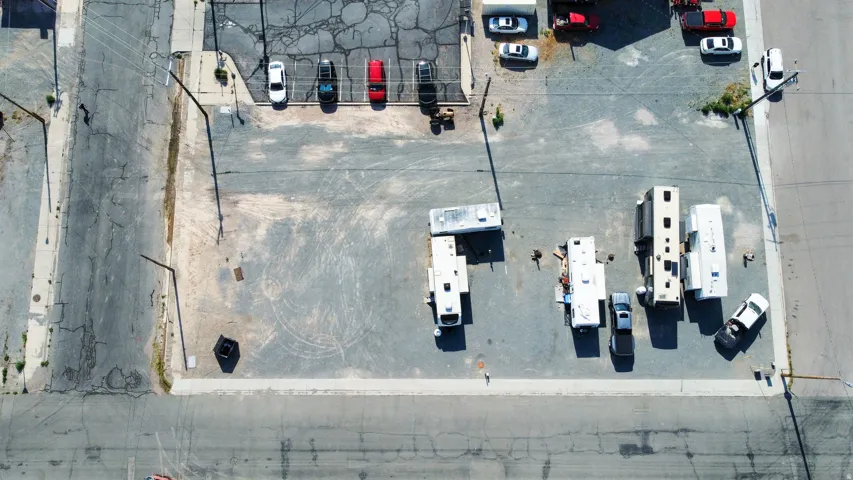 Expansive paved lot with varied surface textures