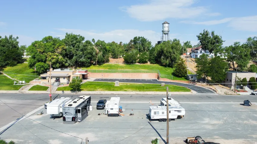 Gravel lot featuring multiple recreational vehicle parking spaces