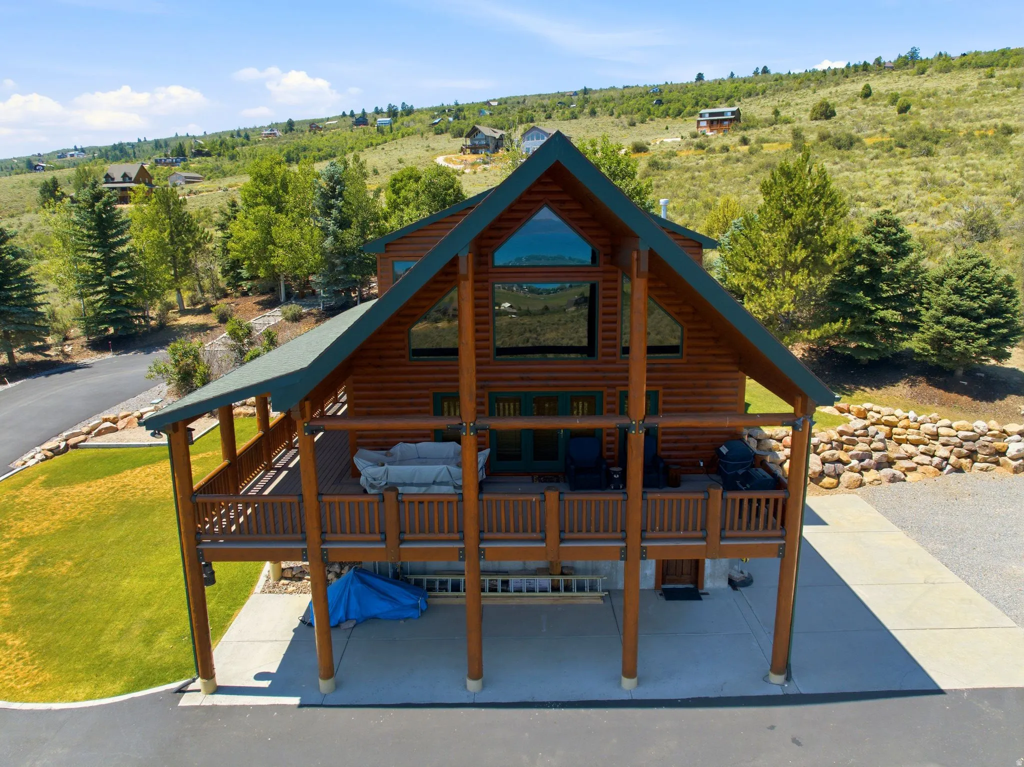 Log-style exterior with a prominent A-frame design and dark green roof