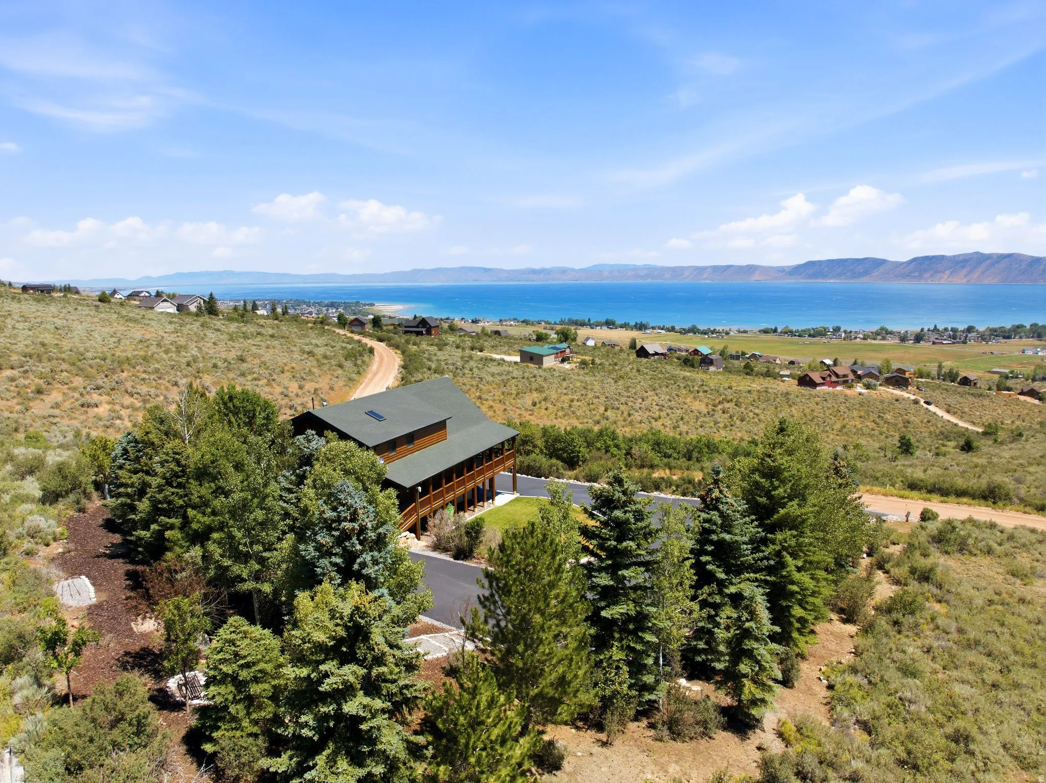 Elevated property featuring a multi-level structure with extensive wrap-around decking