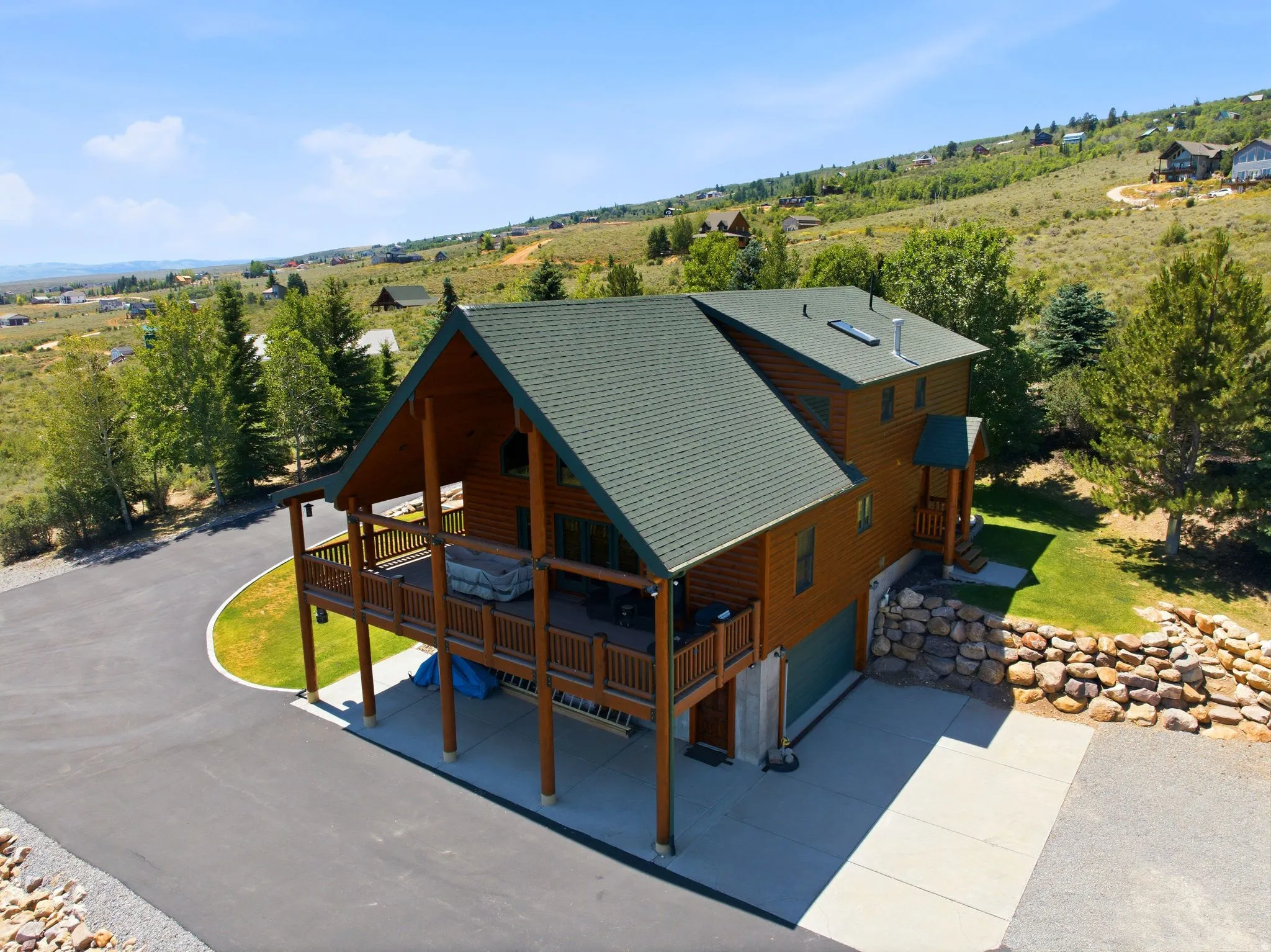 Wood-sided residence featuring a multi-level deck and an attached garage