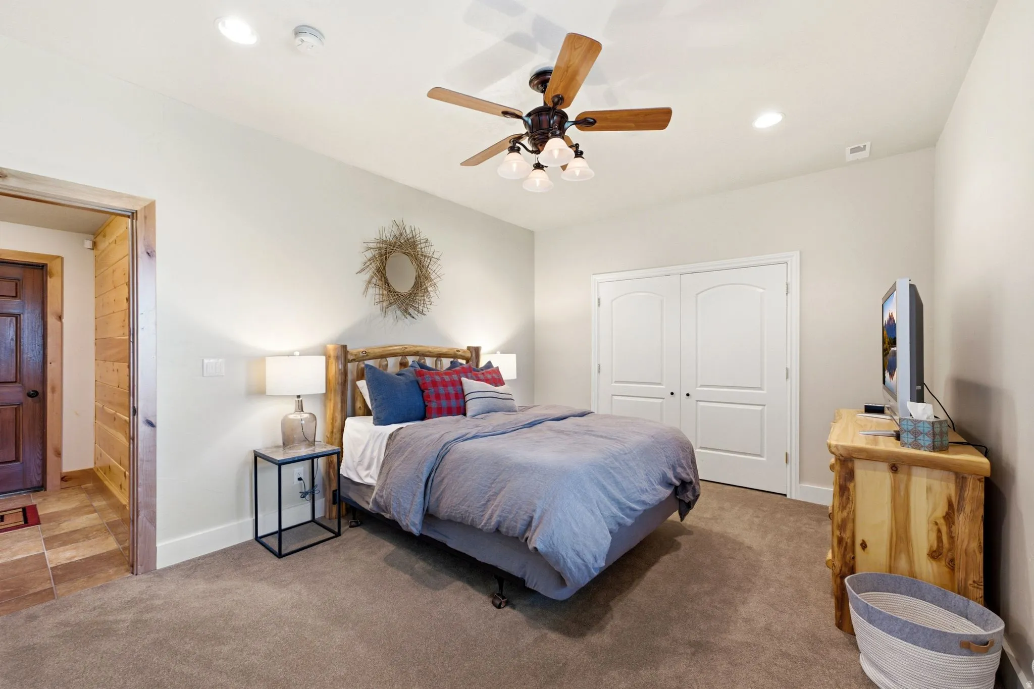 Carpeted room featuring a ceiling fan with integrated lighting, recessed lighting, and a double-door closet