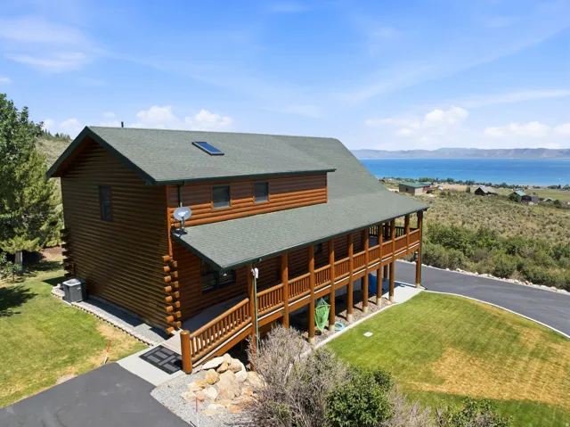 Log cabin-style residence featuring a prominent view of Bear Lake