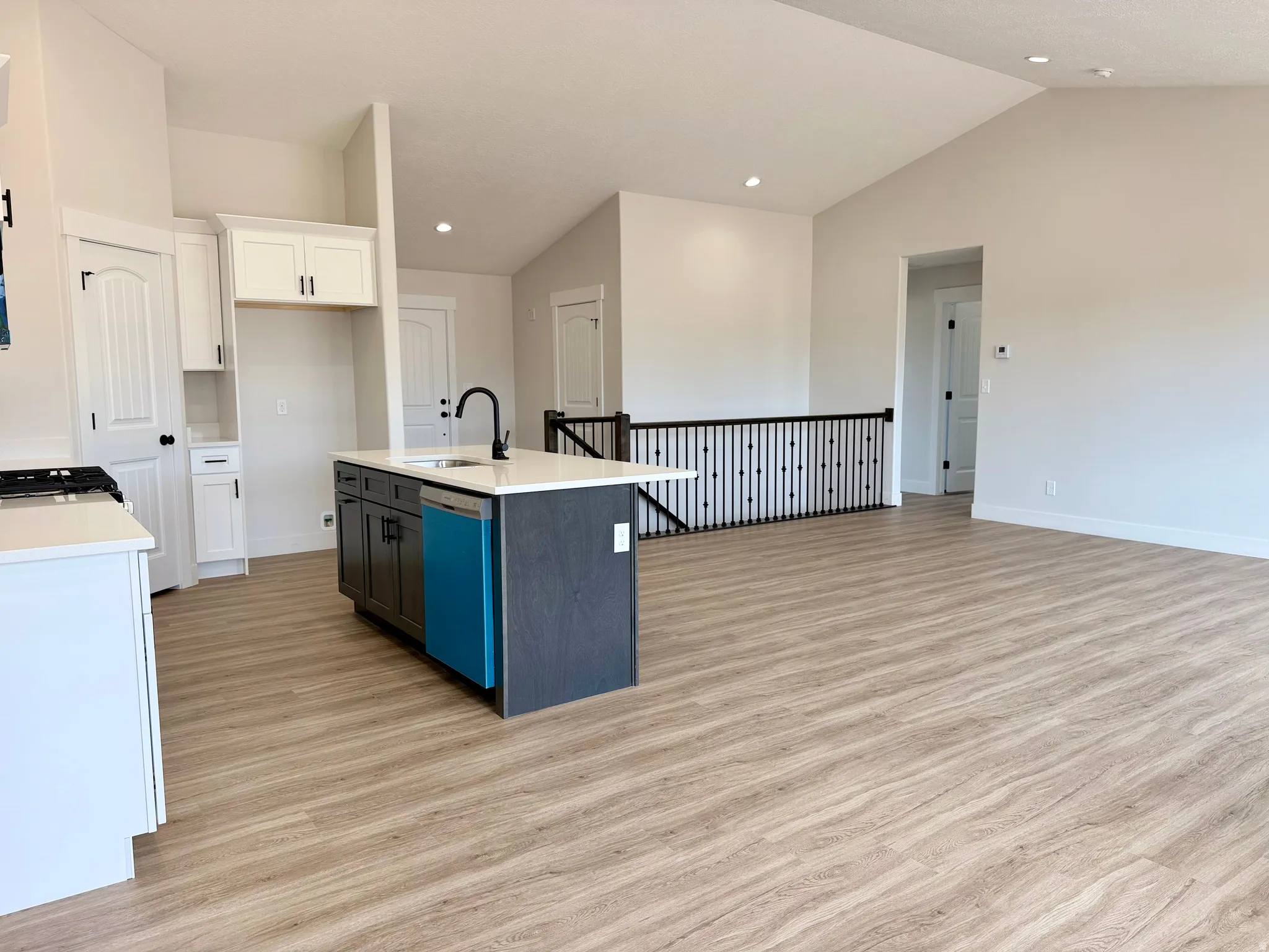 Kitchen with two-tone custom cabinetry with soft-close. Center island sink and dishwasher