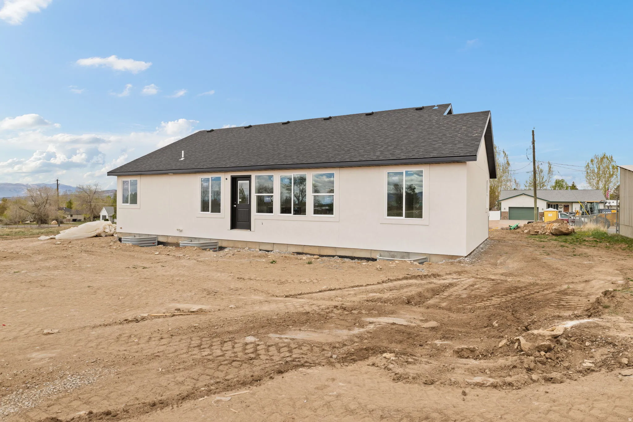 Newly constructed single-story residence with a dark asphalt shingle roof